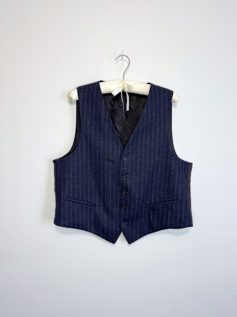 Pinstripe vest featuring a tailored and classic five-button closure